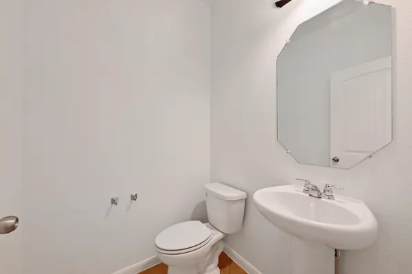 a bathroom with a sink toilet and a mirror