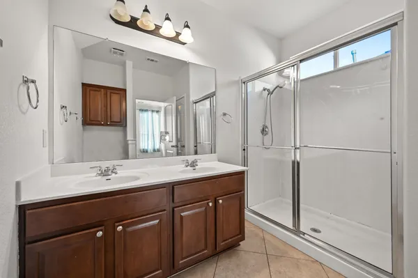 a bathroom with a sink double vanity and a mirror