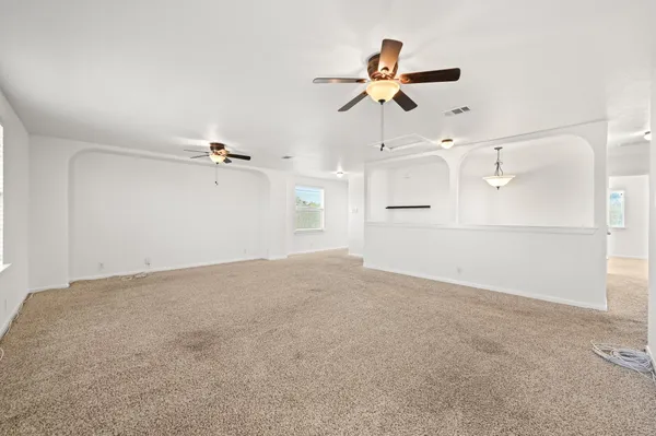 a view of a big room with wooden floor closet and windows