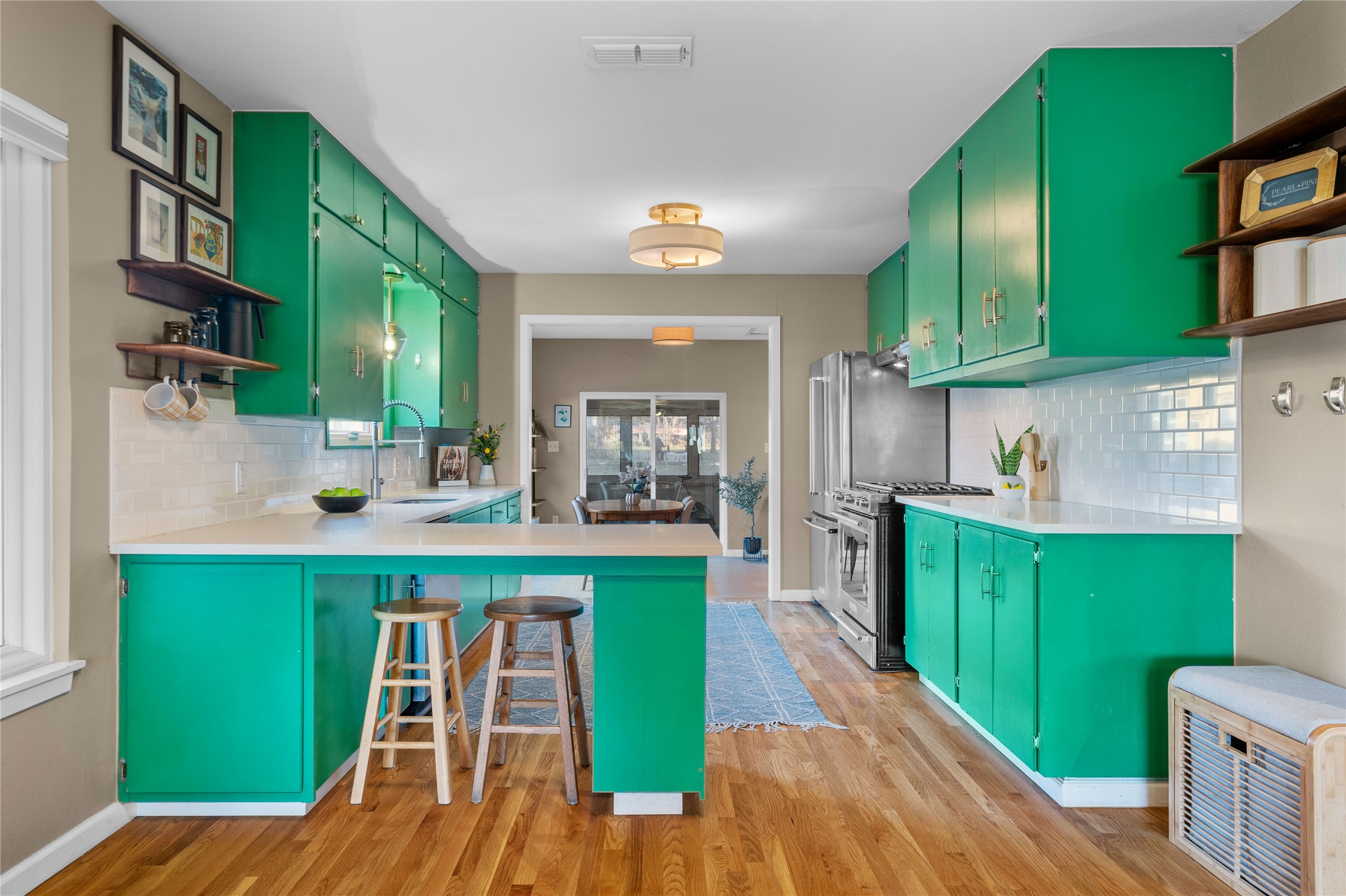 5505 Joe Sayers Avenue Austin, TX 78756 - Photo 9 of 29 Kitchen features quartz countertops and KitchenAid stainless appliances.