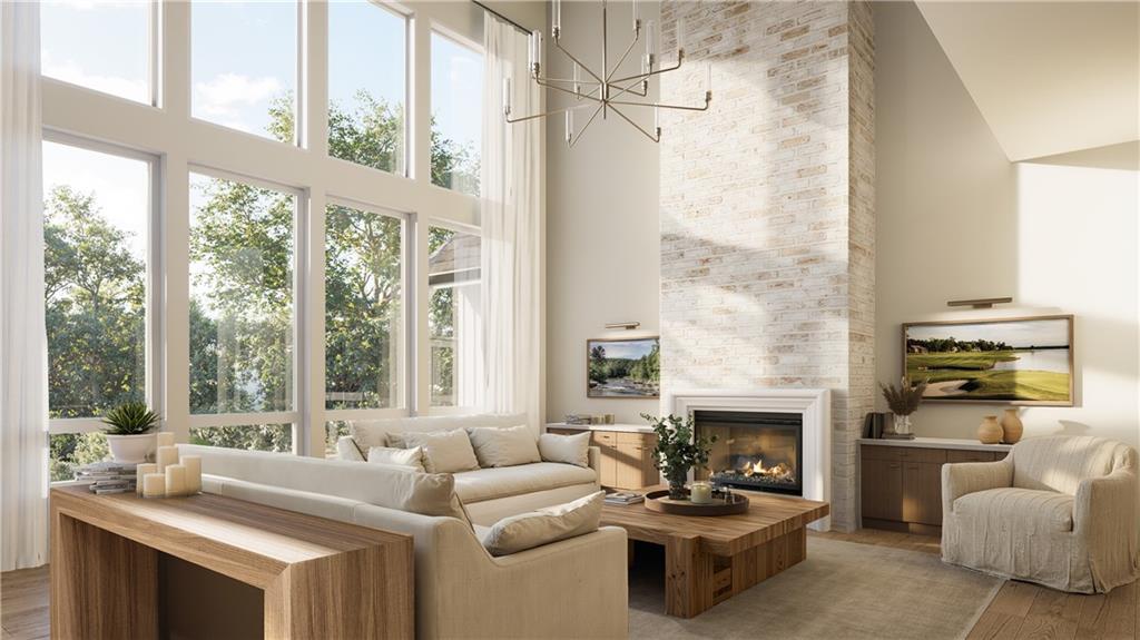 8450 Forsyth Commons Cumming, GA 30041 - Photo 2 of 11 a living room with furniture a fireplace and a large window