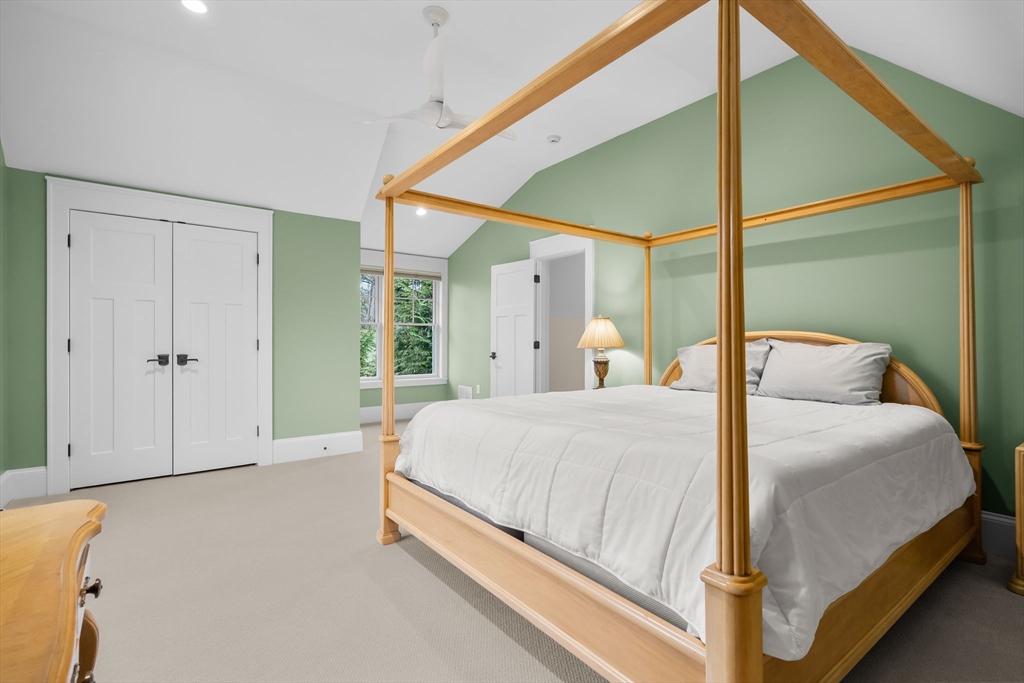 32 Standish Circle Wellesley, MA 02481 - Photo 13 of 29 a bedroom with a bed and a chandelier