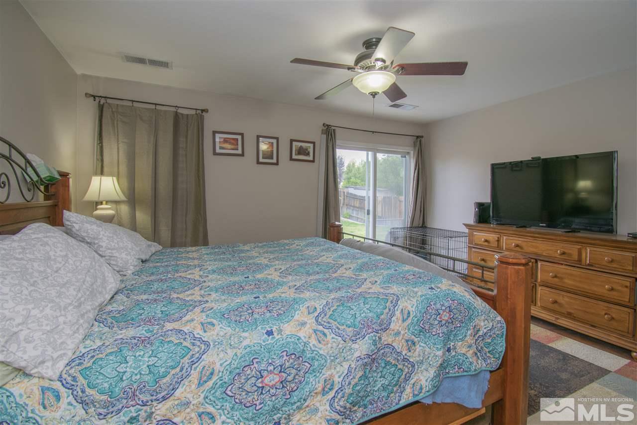 7749 Welsh Drive Reno, NV 89506 - Photo 13 of 25 a bedroom with a bed and a flat screen tv