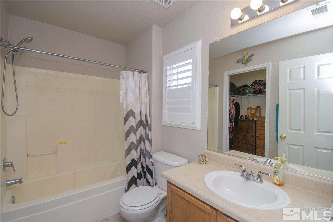 7749 Welsh Drive Reno, NV 89506 - Photo 15 of 25 a bathroom with a sink toilet and shower