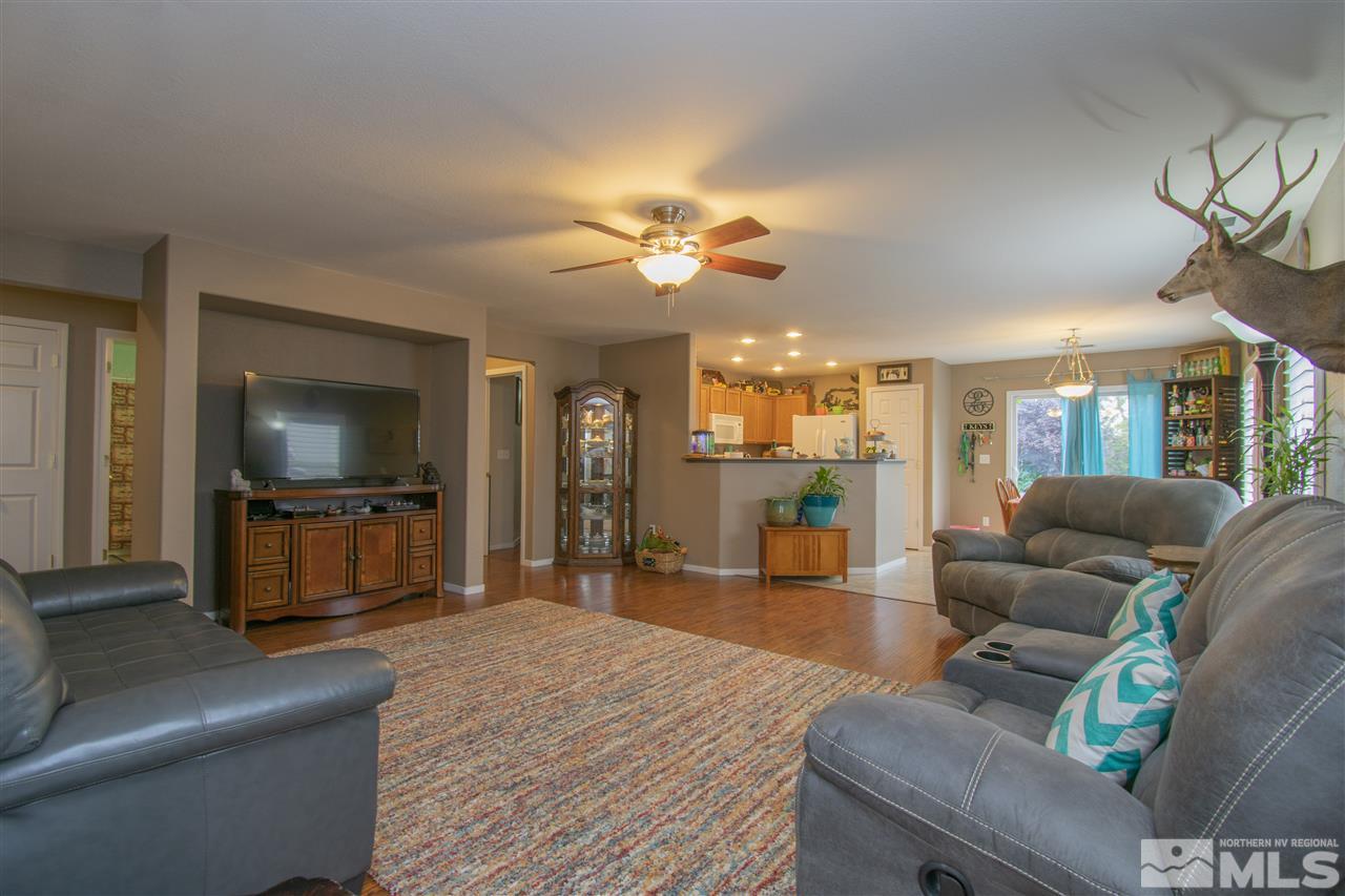 7749 Welsh Drive Reno, NV 89506 - Photo 4 of 25 a living room with furniture and a flat screen tv