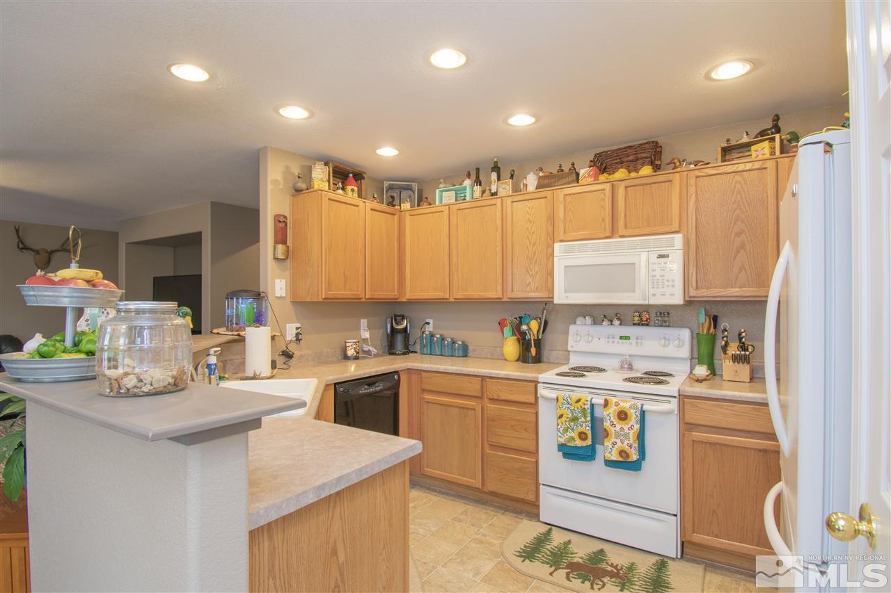 7749 Welsh Drive Reno, NV 89506 - Photo 7 of 25 a kitchen with a sink a stove a refrigerator and a refrigerator
