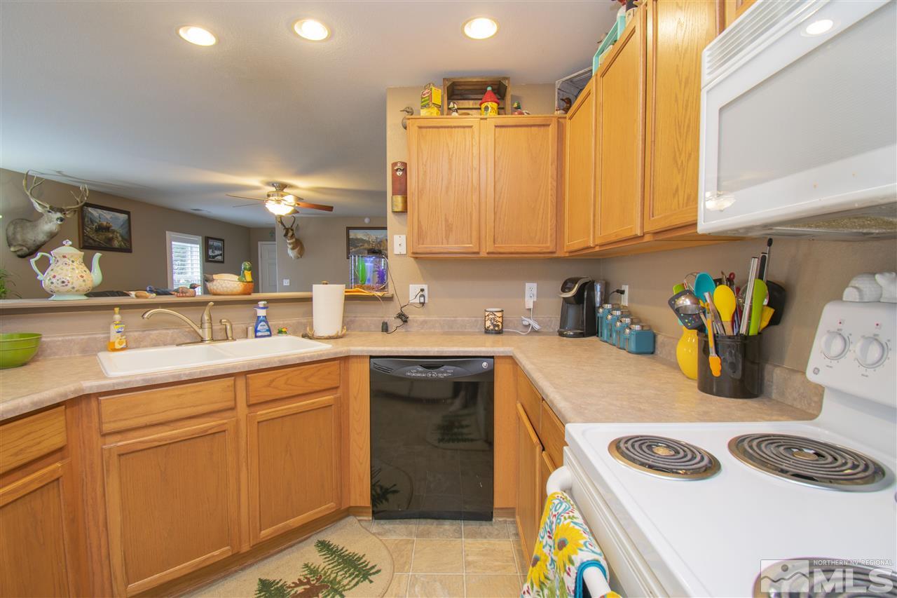 7749 Welsh Drive Reno, NV 89506 - Photo 8 of 25 a kitchen with a sink a stove and cabinets