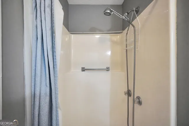a bathroom with a glass shower door
