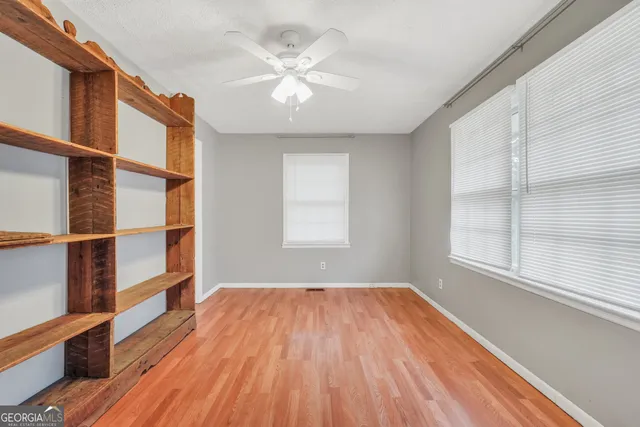 wooden floor in an empty room with a window