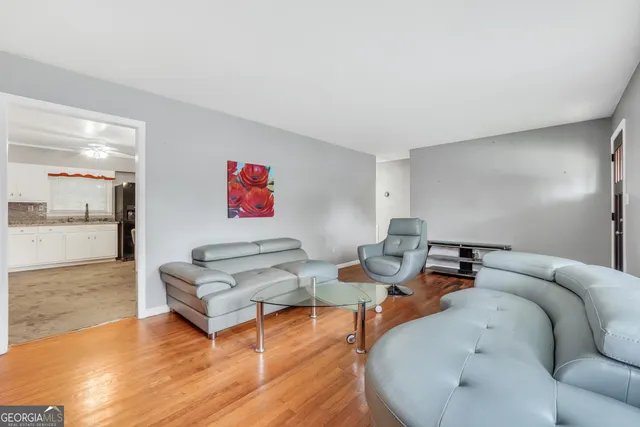 a living room with furniture and wooden floor