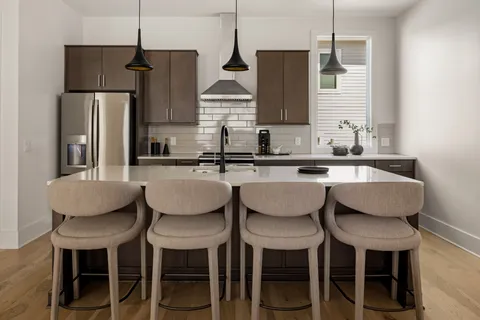 a kitchen with a sink stainless steel appliances and cabinets