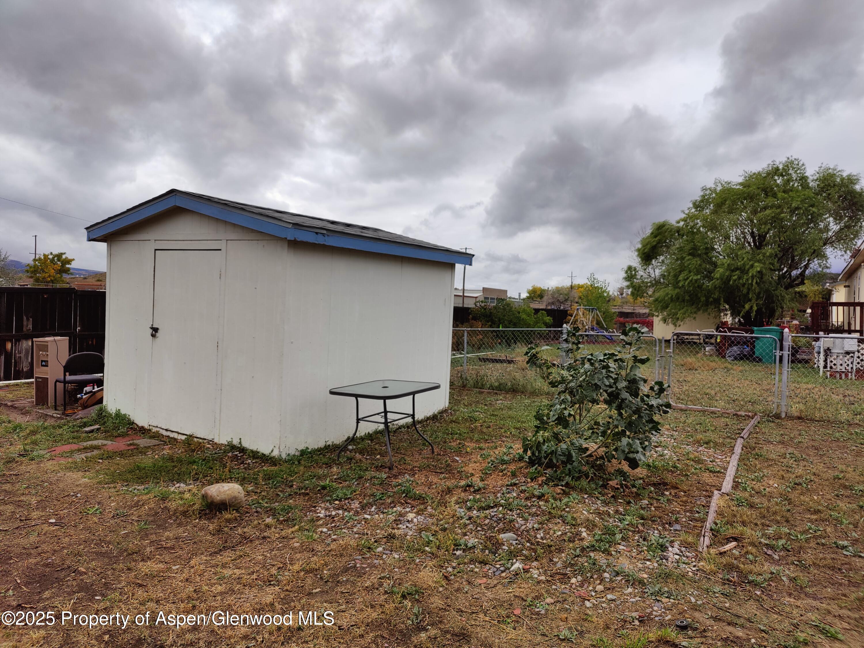 200 West 20th Street, Unit A 128 Rifle, CO 81650 - Photo 2 of 3 a backyard of a house with table and chairs