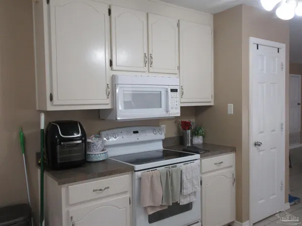a kitchen with cabinets and steel stainless steel appliances