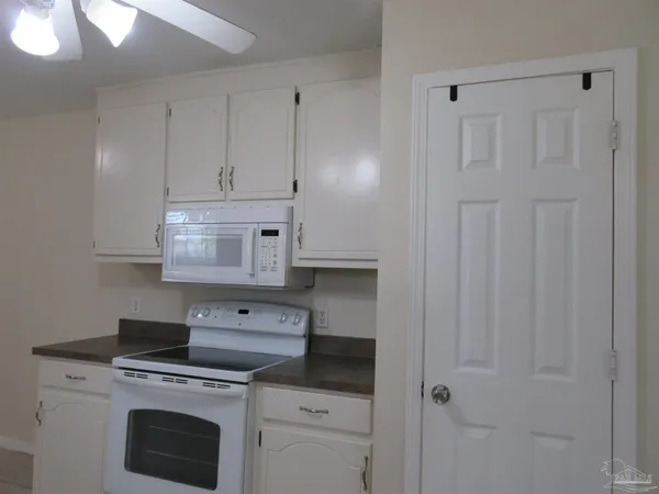 a large kitchen with cabinets and stainless steel appliances