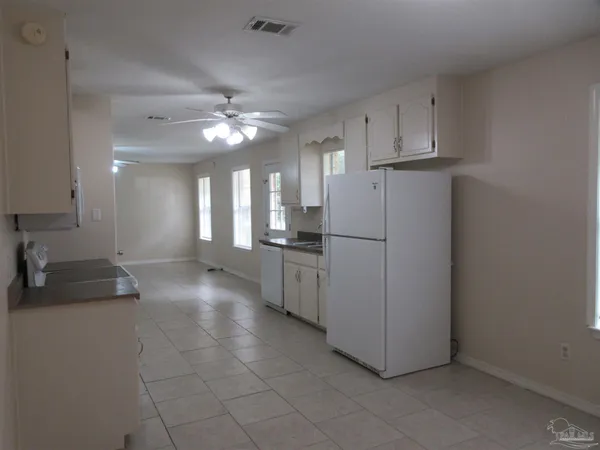 a view of a livingroom with a ceiling fan and window