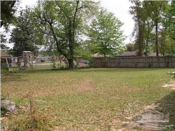a view of a swimming pool with lawn chairs and plants