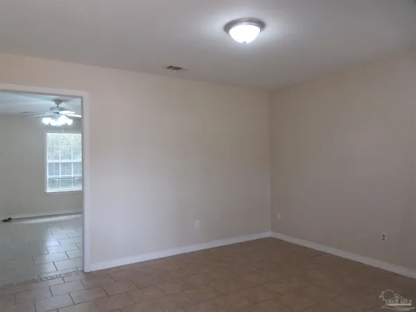 an empty room with a empty space and windows