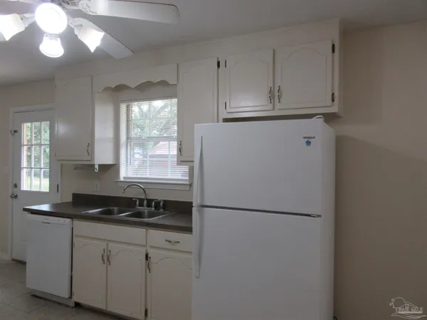 a kitchen with refrigerator a sink and cabinets