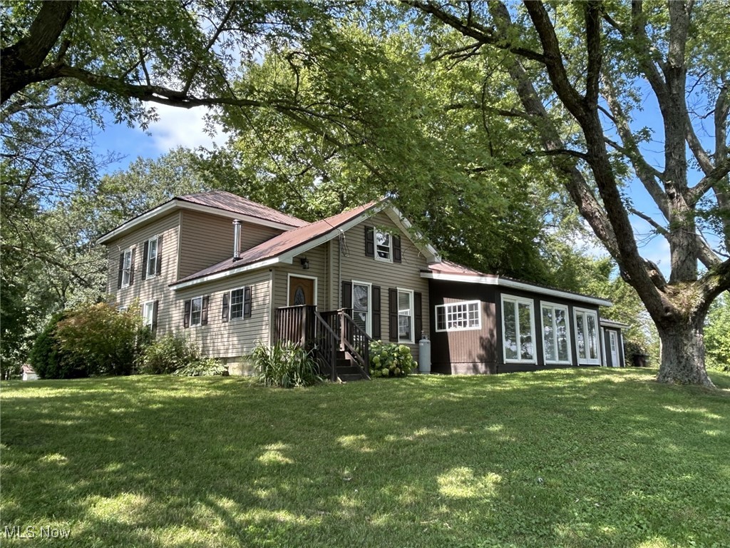 4853 Leon Road Andover, OH 44003 - Photo 23 of 33 View of side of home with a yard