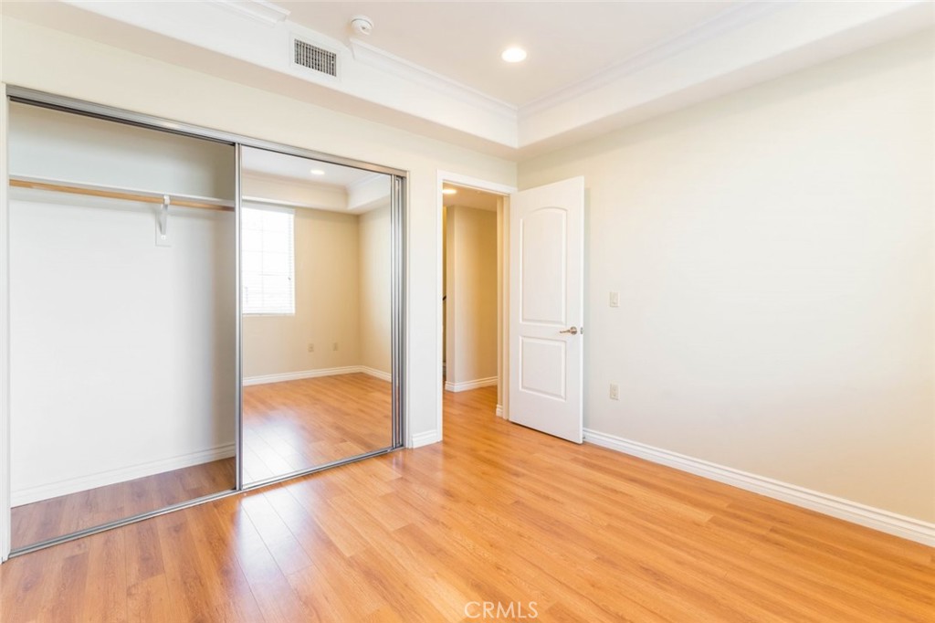 511 East Harvard Road, Unit 101 Burbank, CA 91501 - Photo 19 of 29 an empty room with wooden floor and windows