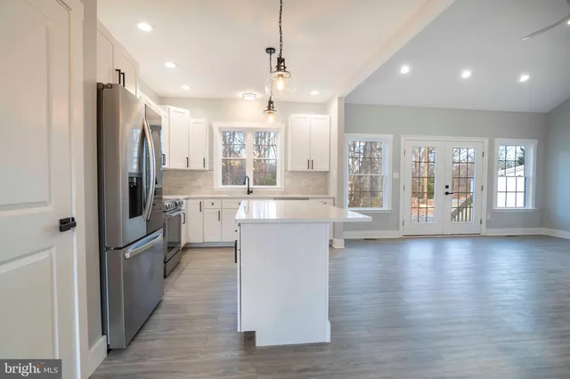 a view of a kitchen with wooden floor and a kitchen