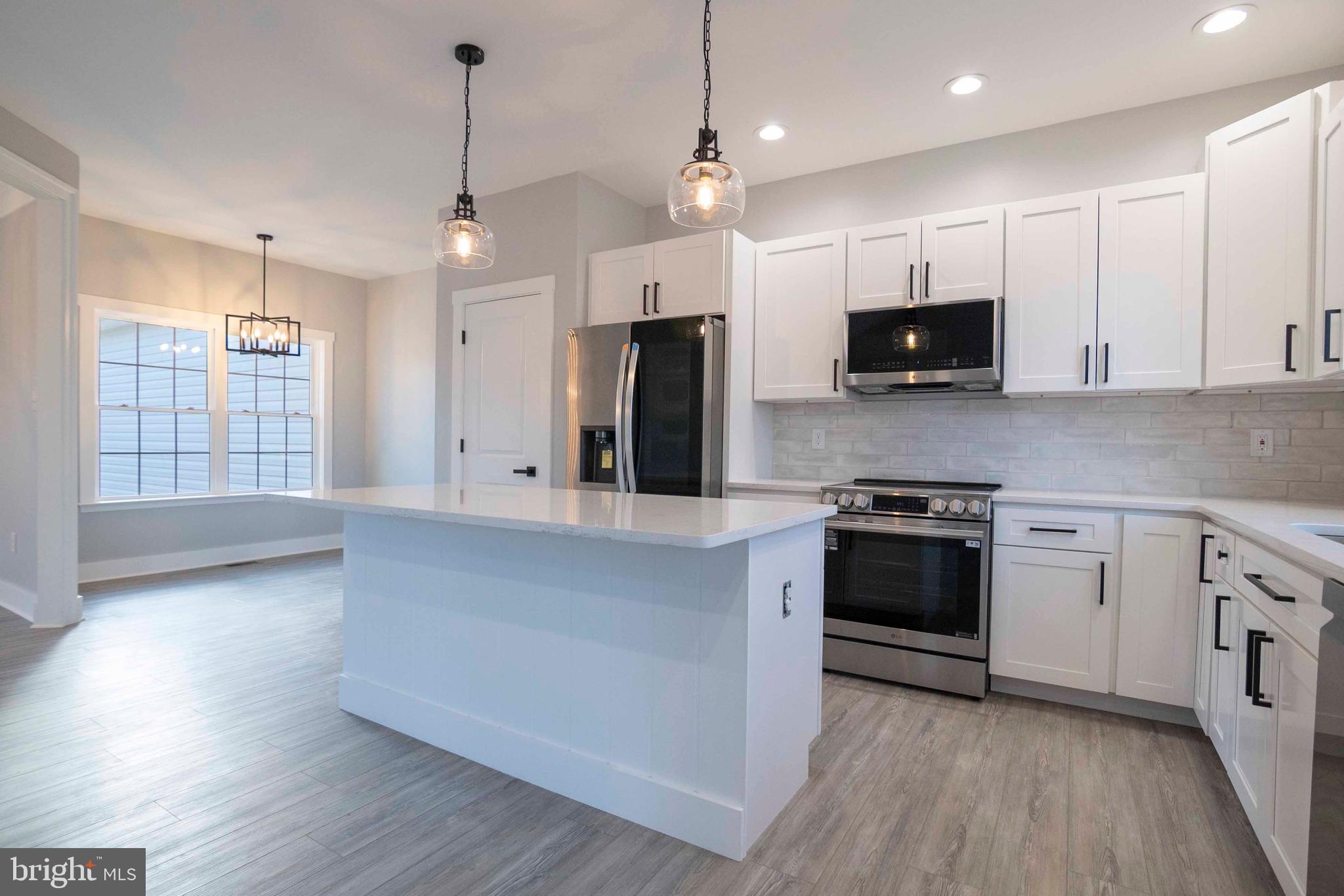 1633 Catlett Mountain Road Front Royal, VA 22630 - Photo 24 of 69 a kitchen with stainless steel appliances kitchen island granite countertop a stove a sink and a microwave