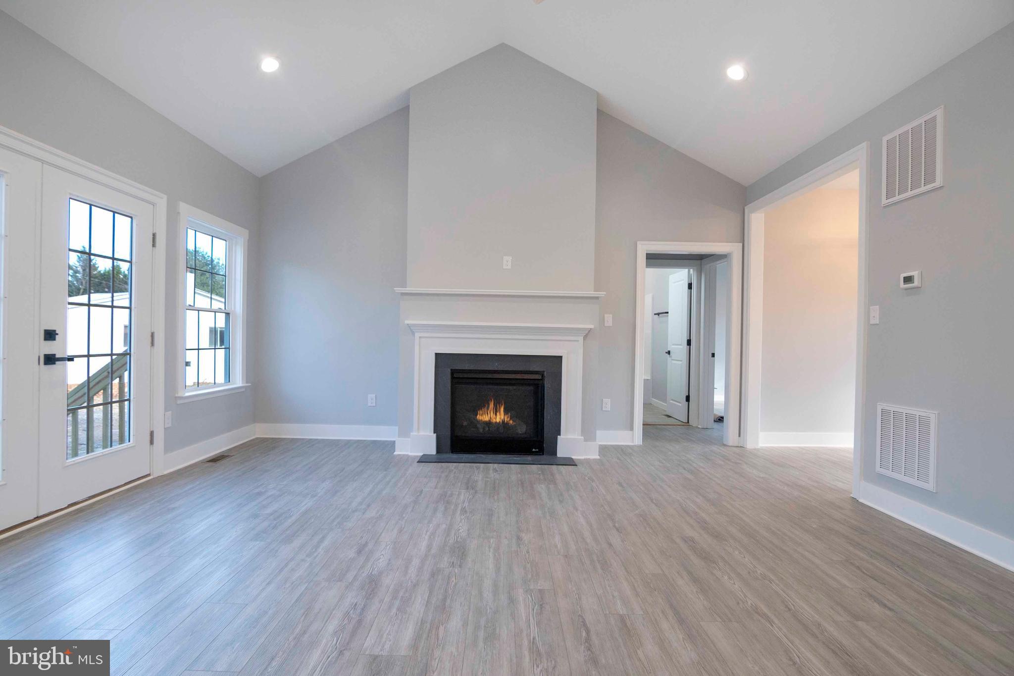 1633 Catlett Mountain Road Front Royal, VA 22630 - Photo 25 of 69 a view of an empty room with wooden floor fireplace and a window