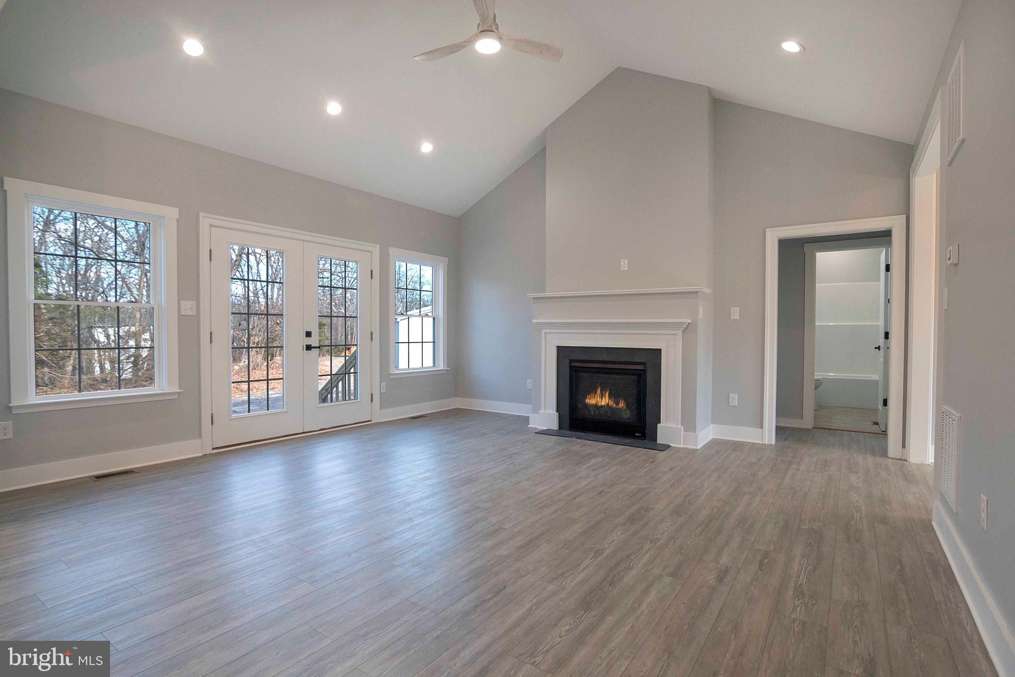 1633 Catlett Mountain Road Front Royal, VA 22630 - Photo 26 of 69 a view of an empty room with wooden floor and a fireplace