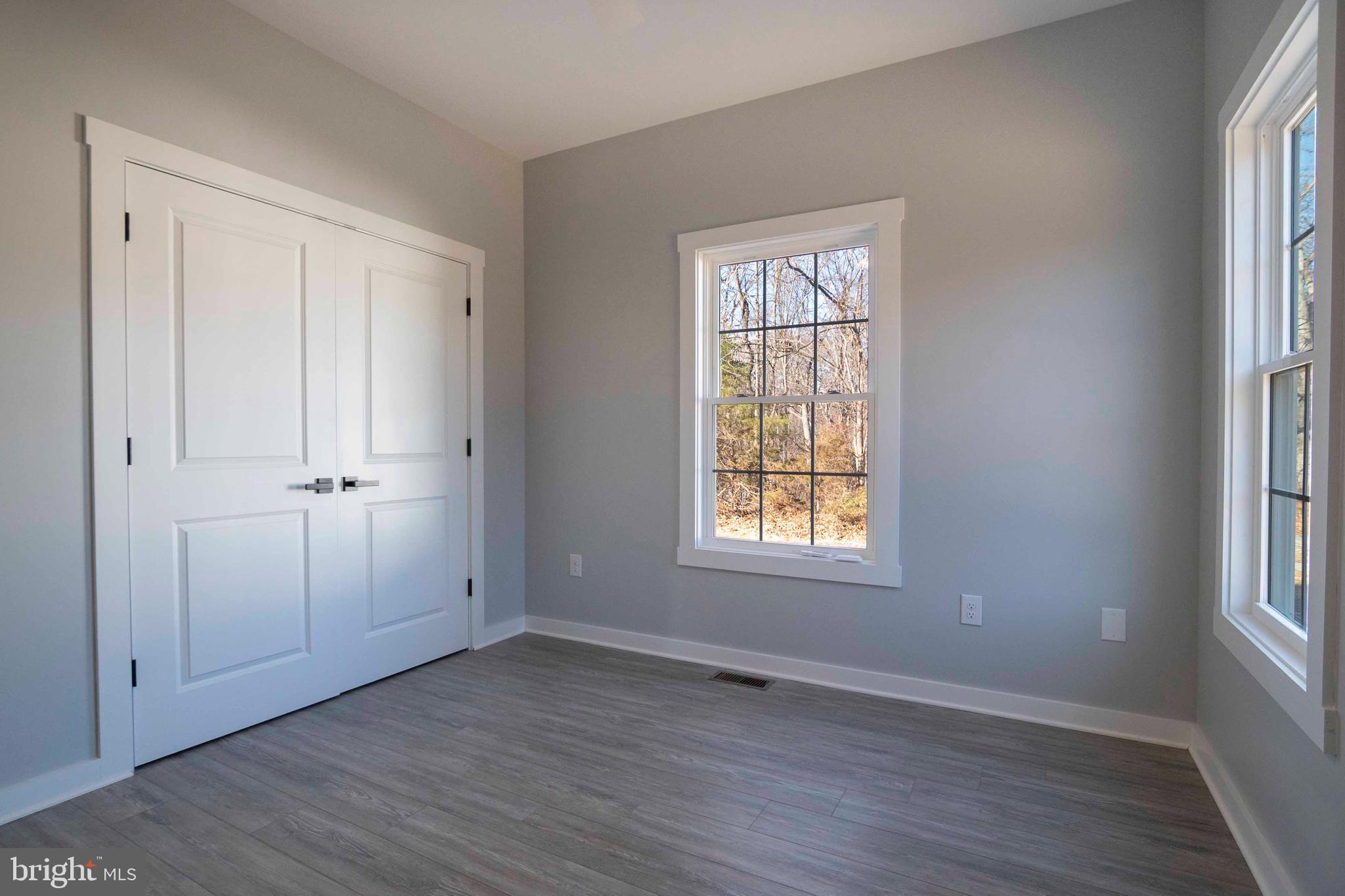 1633 Catlett Mountain Road Front Royal, VA 22630 - Photo 38 of 69 an empty room with wooden floor and windows