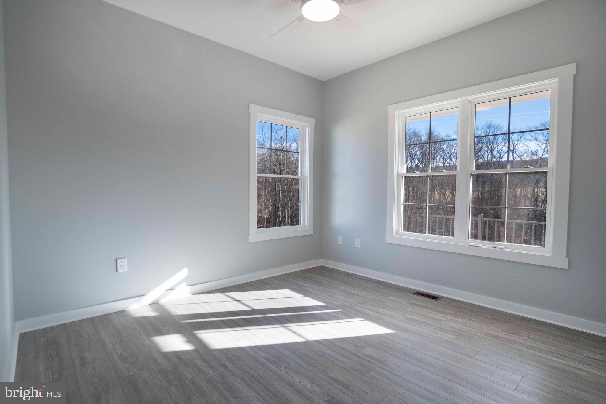 1633 Catlett Mountain Road Front Royal, VA 22630 - Photo 39 of 69 an empty room with wooden floor and windows