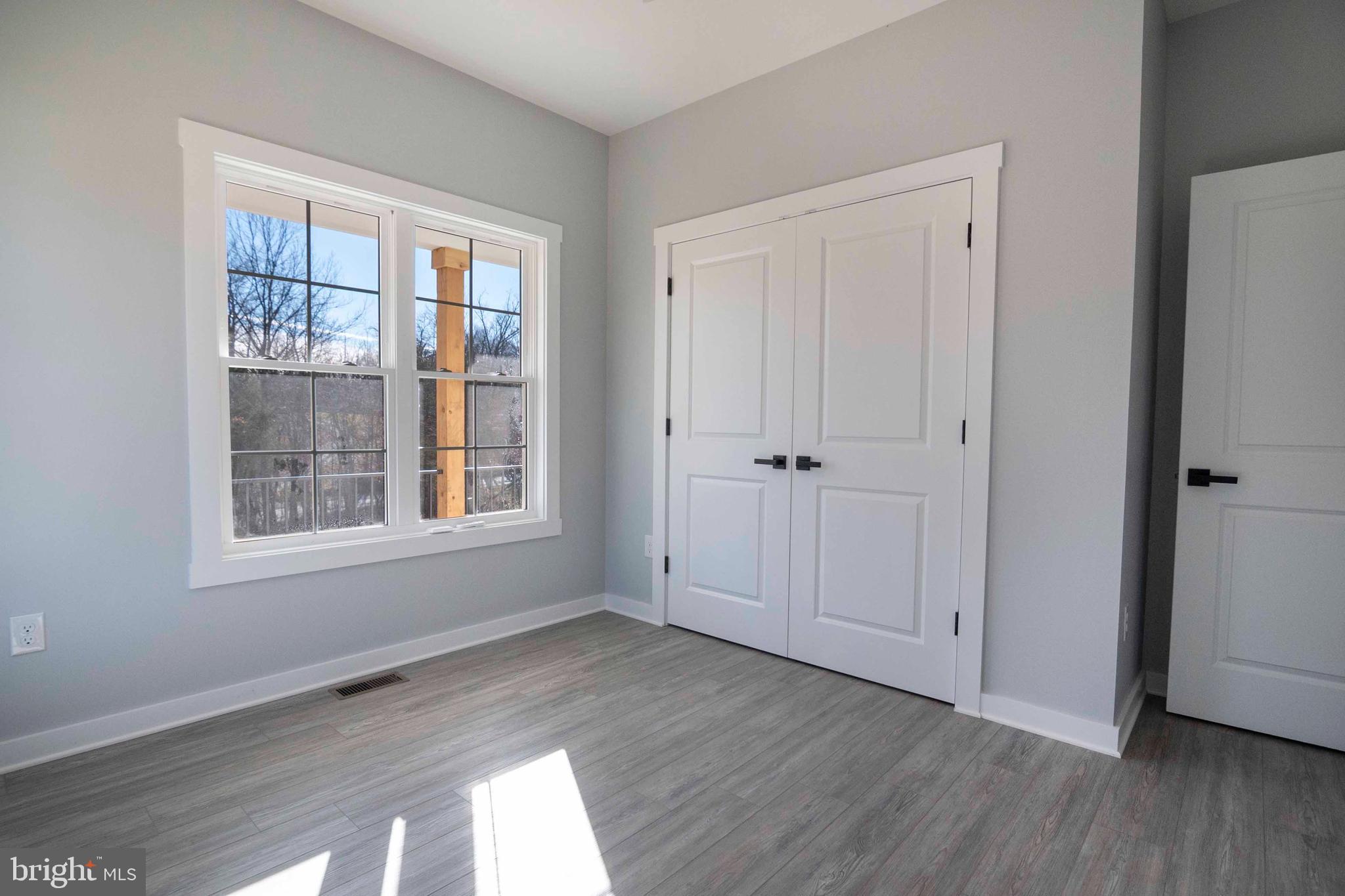 1633 Catlett Mountain Road Front Royal, VA 22630 - Photo 41 of 69 a view of an empty room with wooden floor and a window