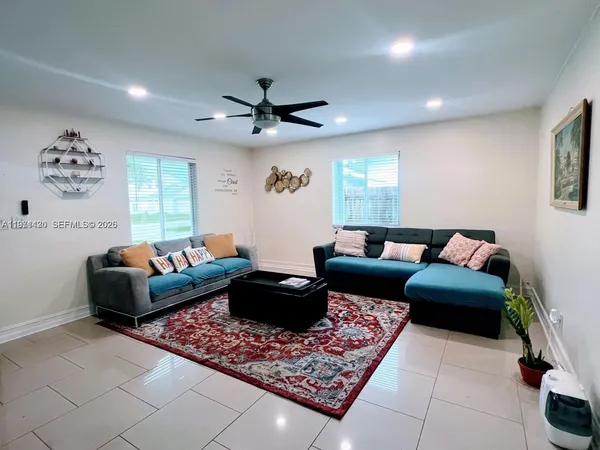a living room with furniture rug and window