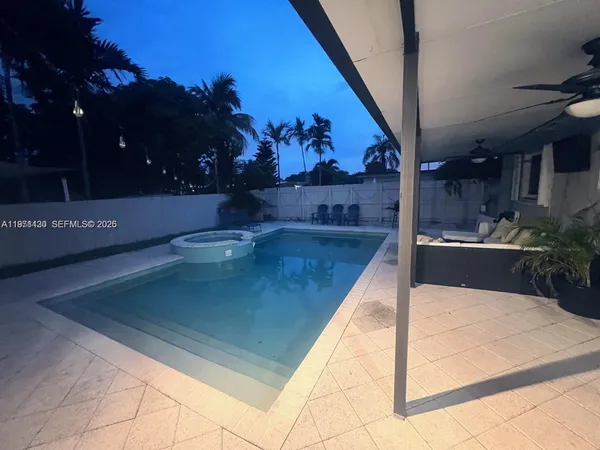 a view of a swimming pool with an outdoor seating
