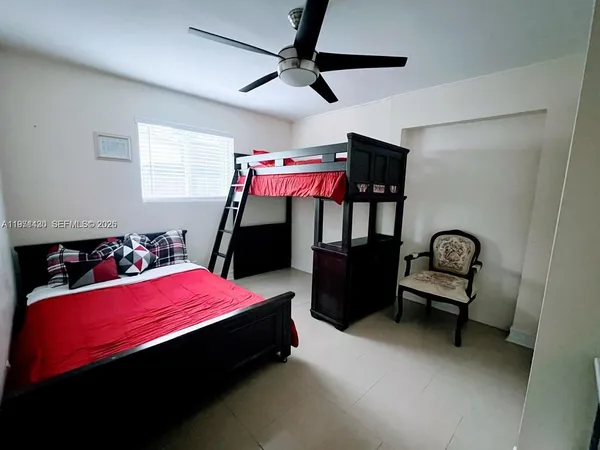 a bed room with a bed and a chair