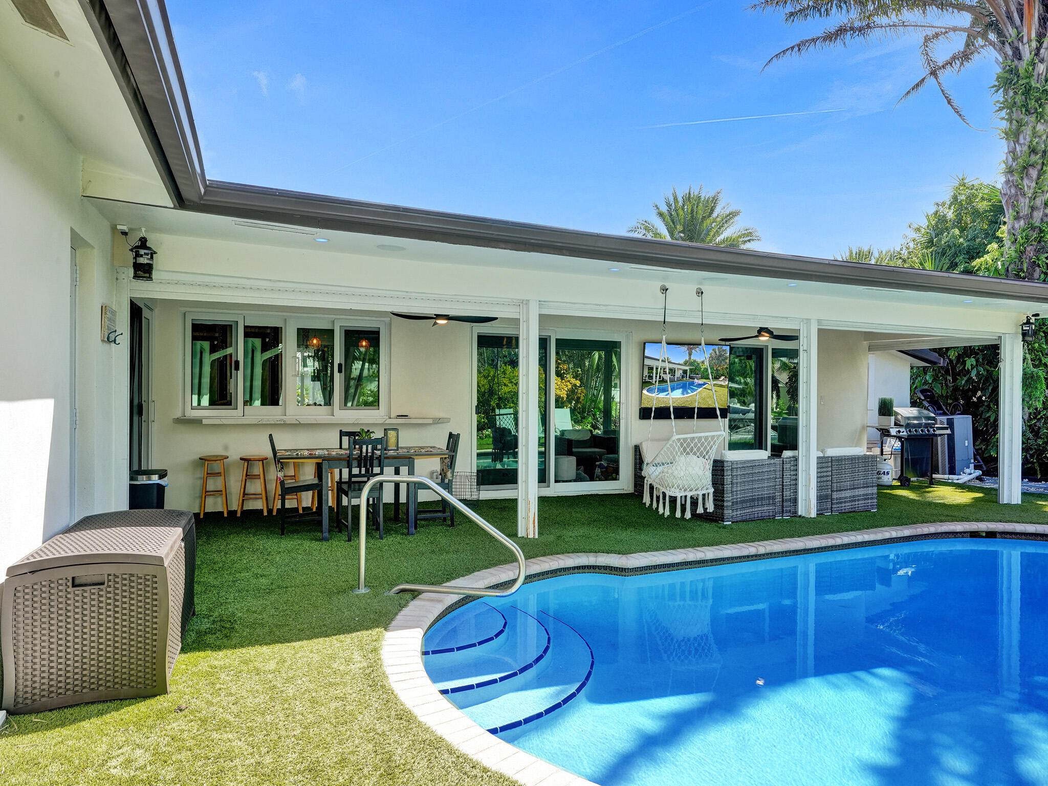 a view of a house with a backyard porch and sitting area