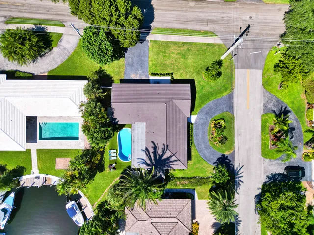 a view of a house with swimming pool and furniture