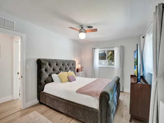 a bedroom with a bed and a painting on the wall