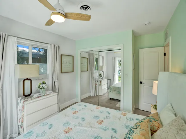 a bedroom with a bed and a large window