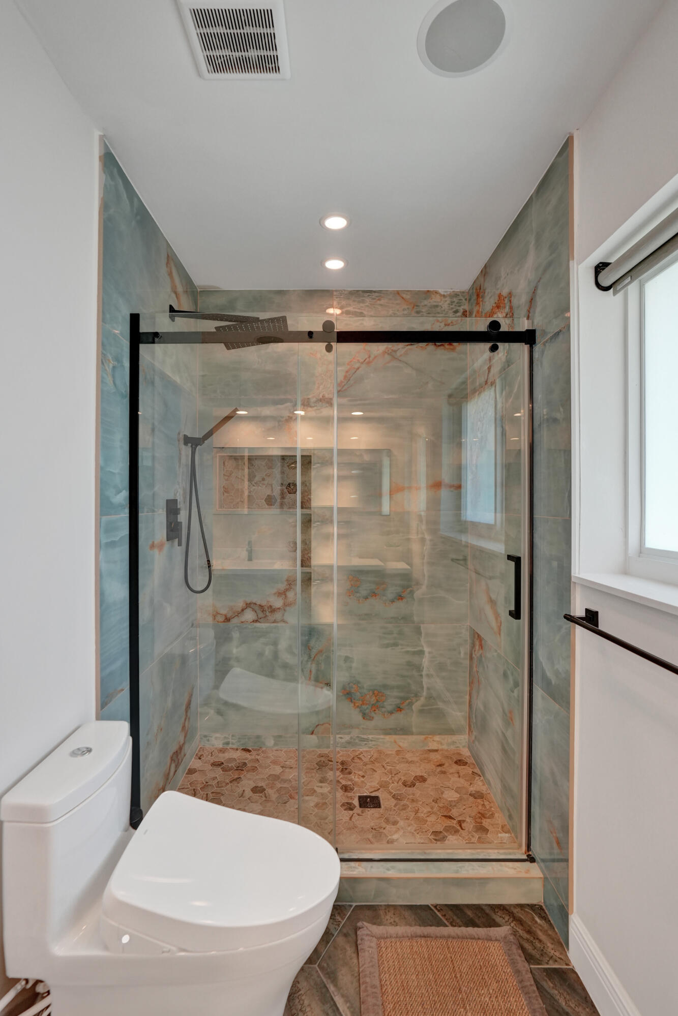 3821 Northeast 29th Avenue Lighthouse Point, FL 33064 - Photo 29 of 59 a bathroom with a shower a toilet and a window