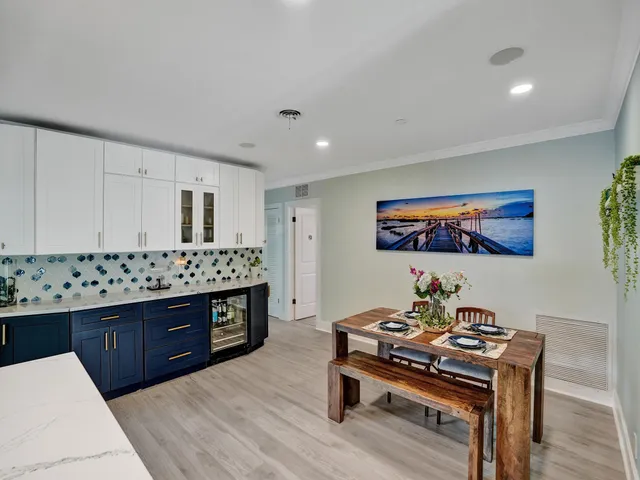 a bathroom with a tub sink double vanity and tub