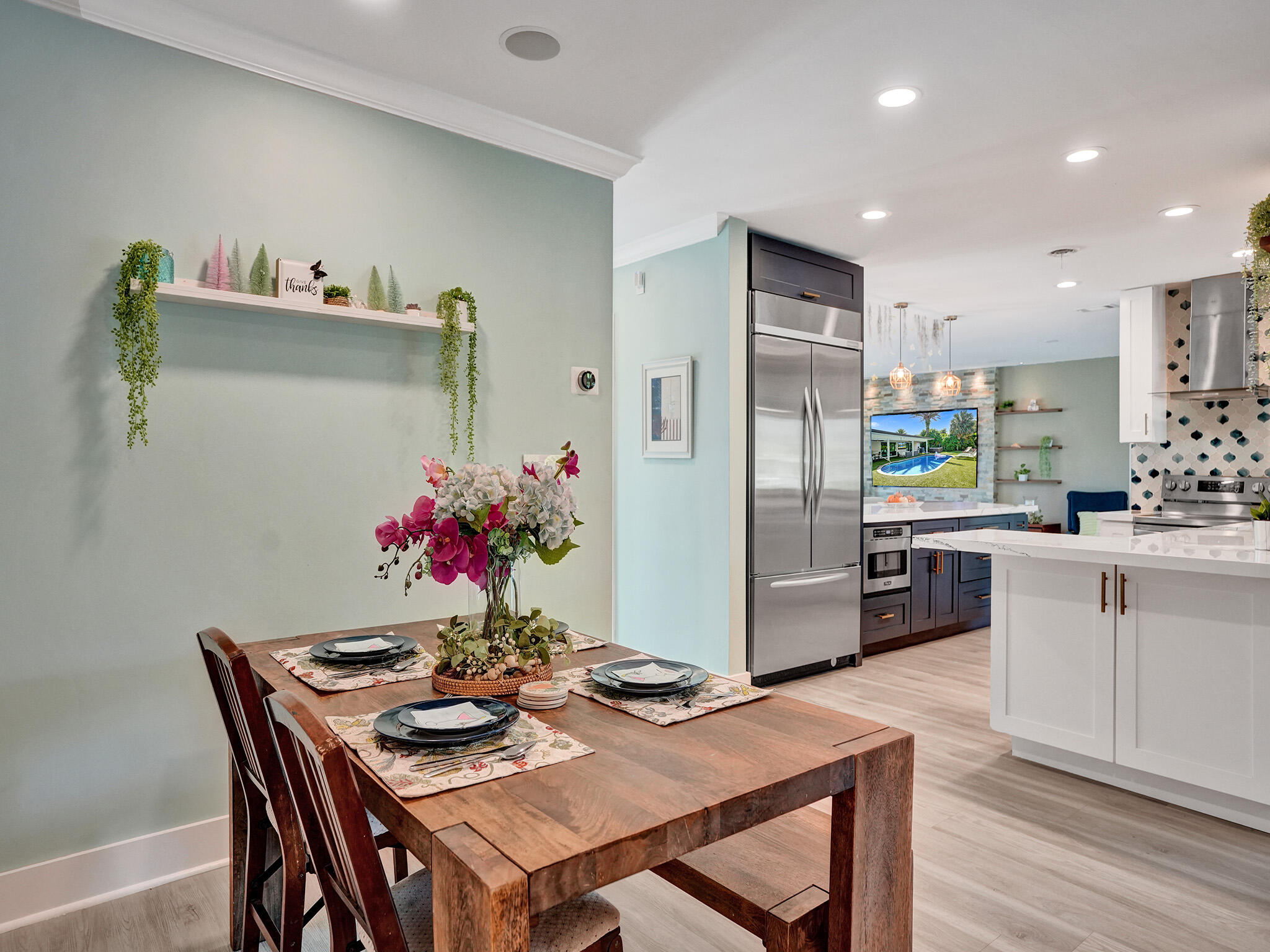 3821 Northeast 29th Avenue Lighthouse Point, FL 33064 - Photo 40 of 59 a kitchen with granite countertop a refrigerator and microwave