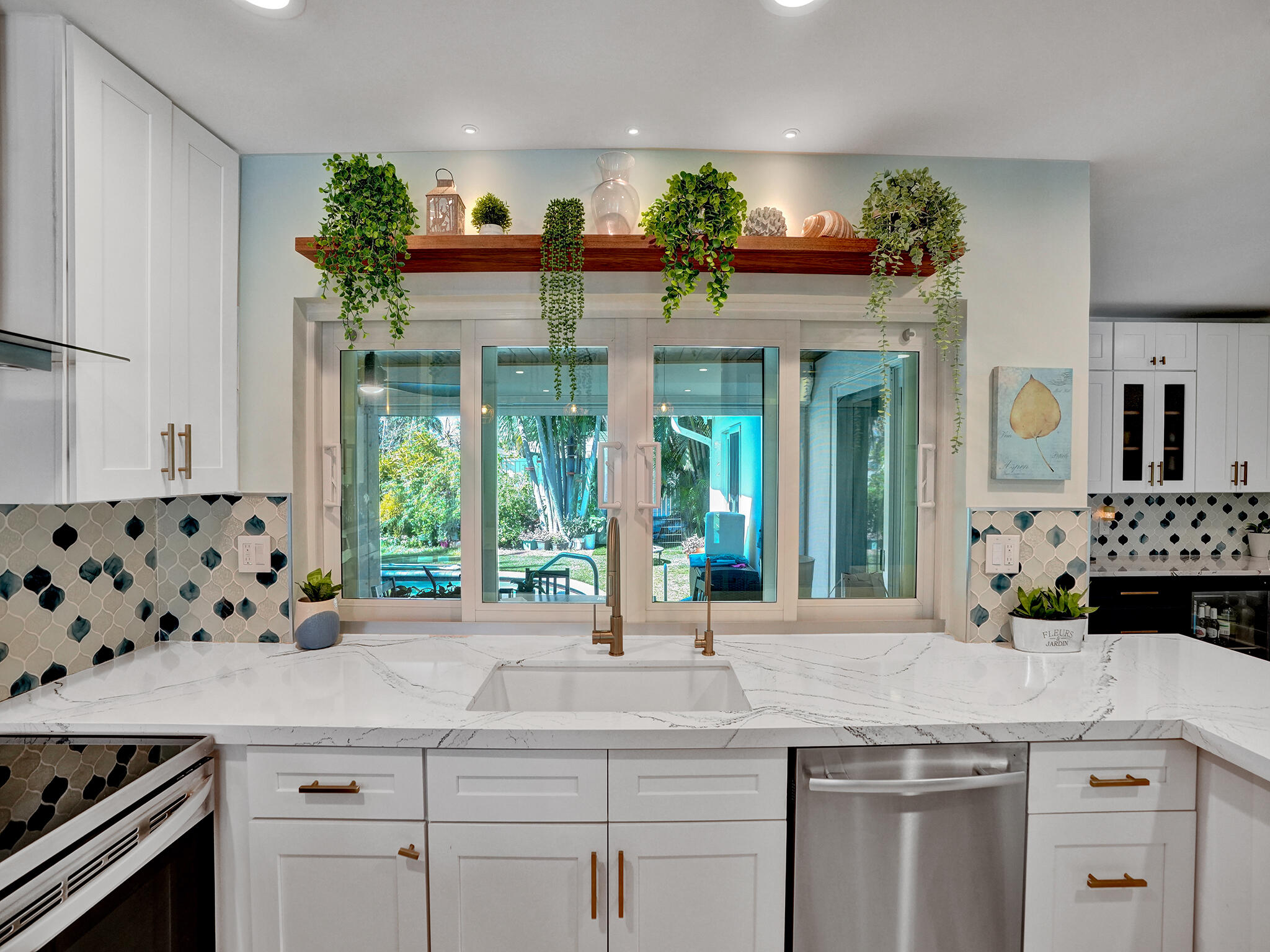 3821 Northeast 29th Avenue Lighthouse Point, FL 33064 - Photo 56 of 59 a kitchen with stainless steel appliances a sink and a large window