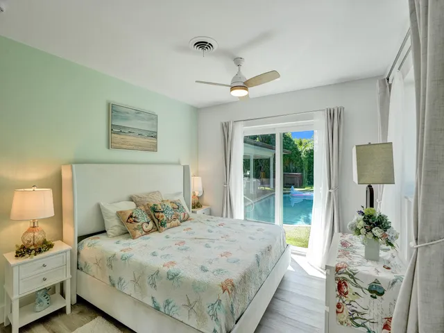 a large bed sitting in a bedroom next to a window