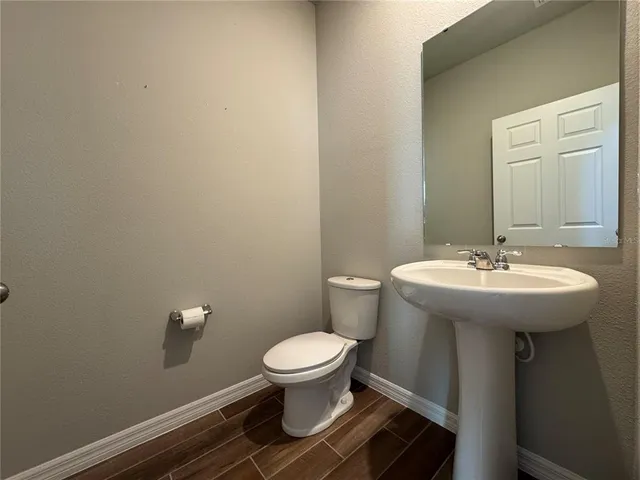 a bathroom with a sink toilet and a mirror