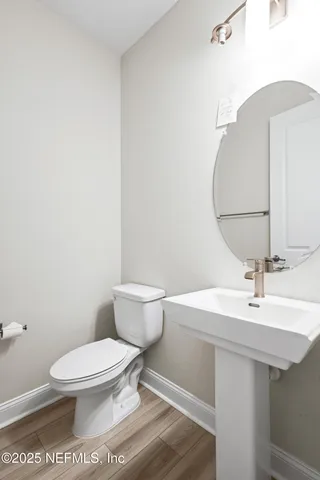 a bathroom with a sink a toilet and mirror
