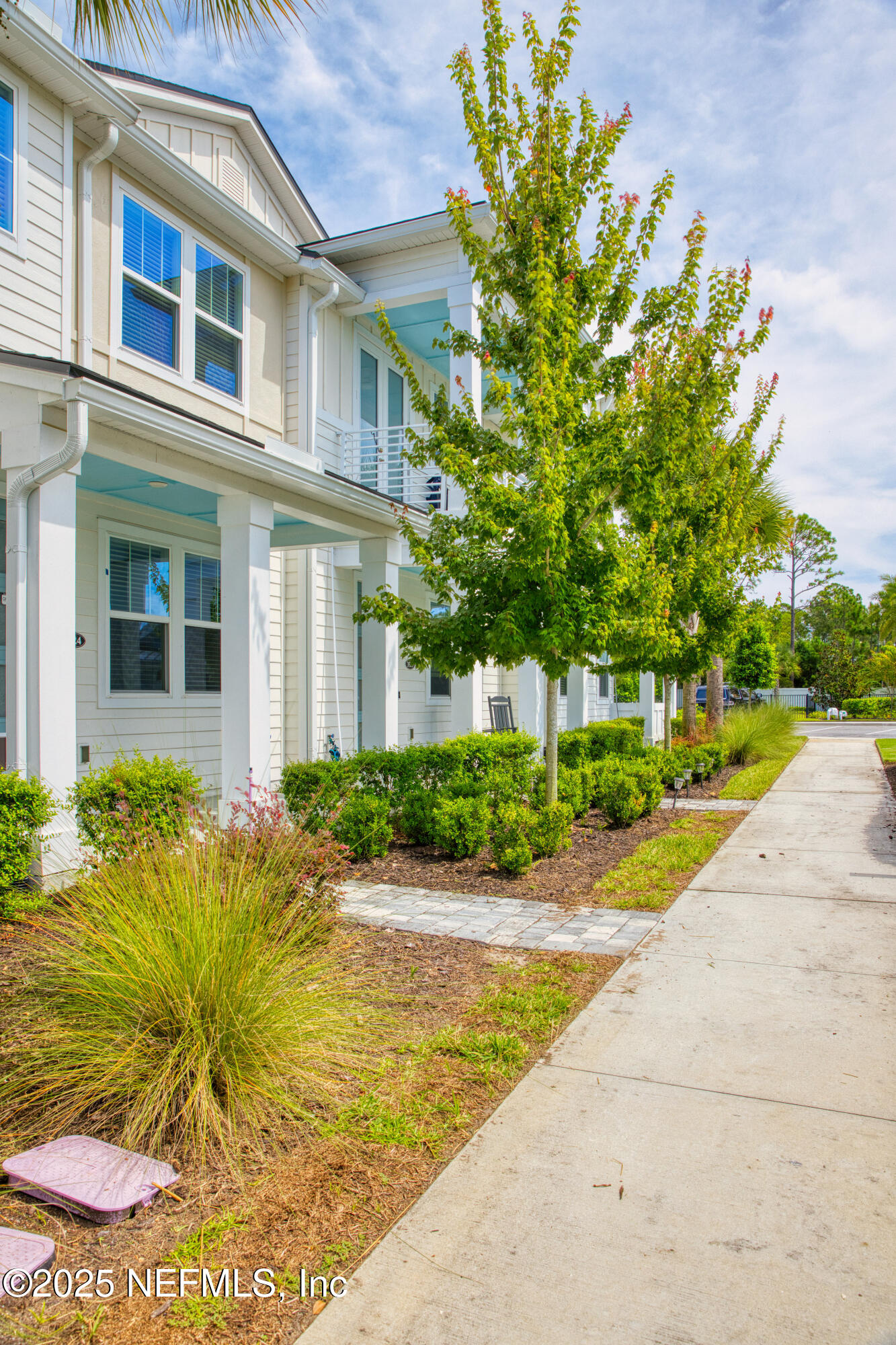 3524 Oystercatcher Way Jacksonville, FL 32224 - Photo 2 of 40 a view of yellow house with a yard and table and chairs in front of it