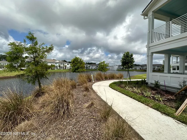 a view of a lake with houses in the back