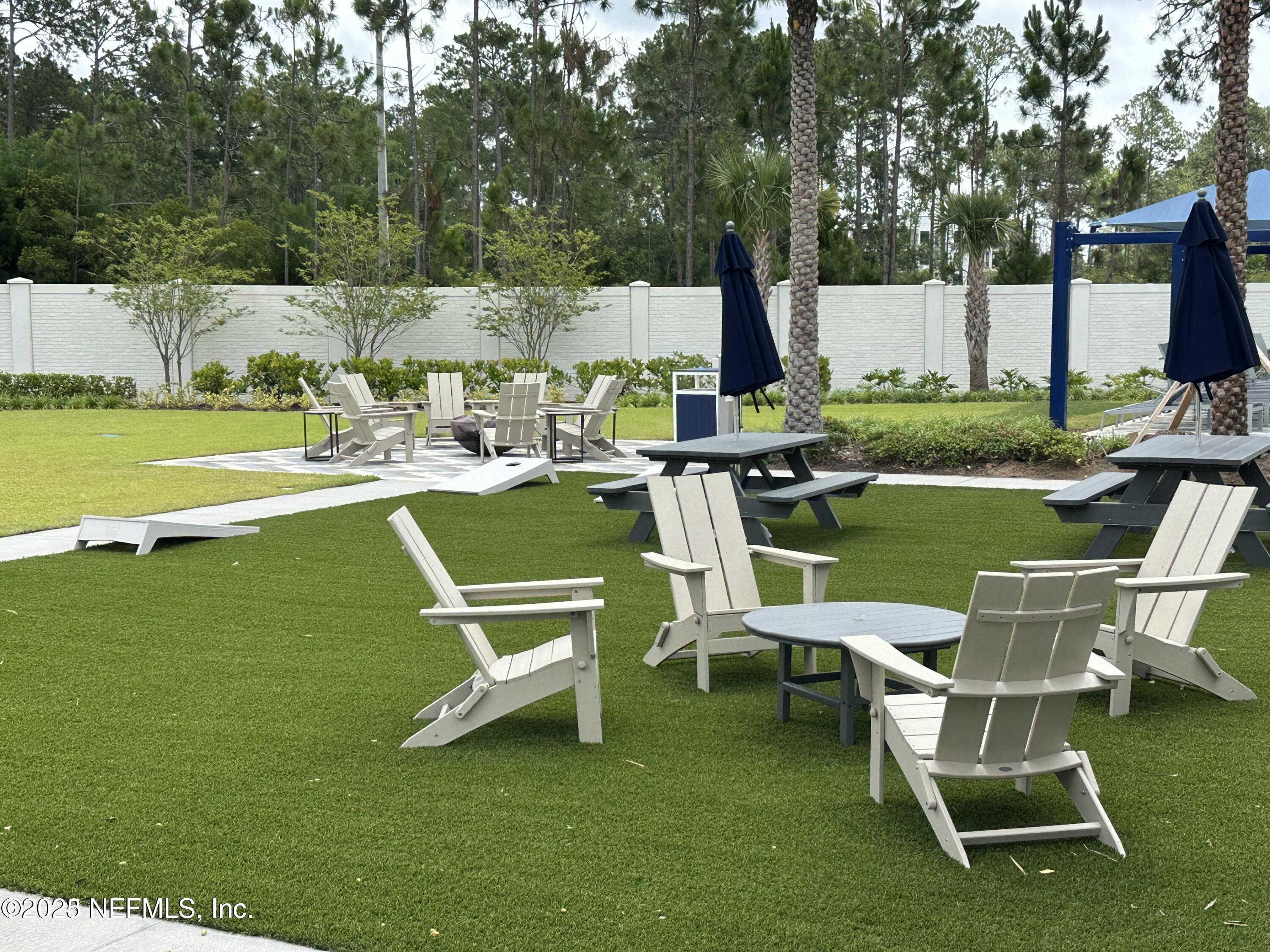 3524 Oystercatcher Way Jacksonville, FL 32224 - Photo 34 of 40 a view of a table and chairs in the garden