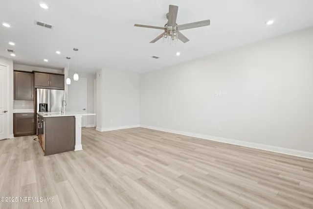 a view of a kitchen with a sink and wooden floor