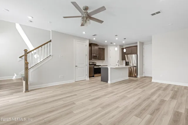 a view of a kitchen with a sink and a refrigerator
